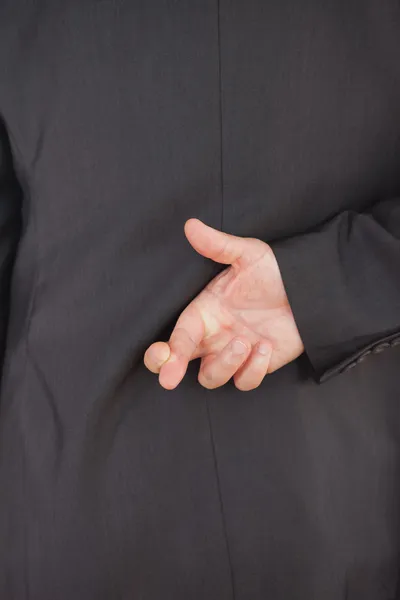 Businessman crossing fingers Stock Image