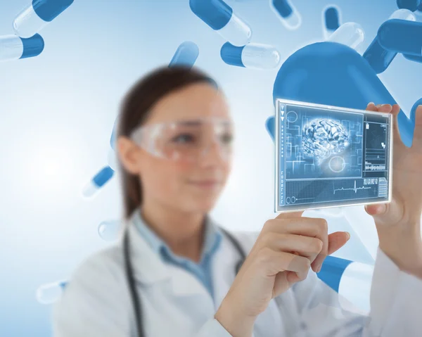 Smiling laboratory worker using virtual screen Stock Image