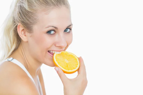 Happy woman biting slice of orange Royalty Free Stock Images