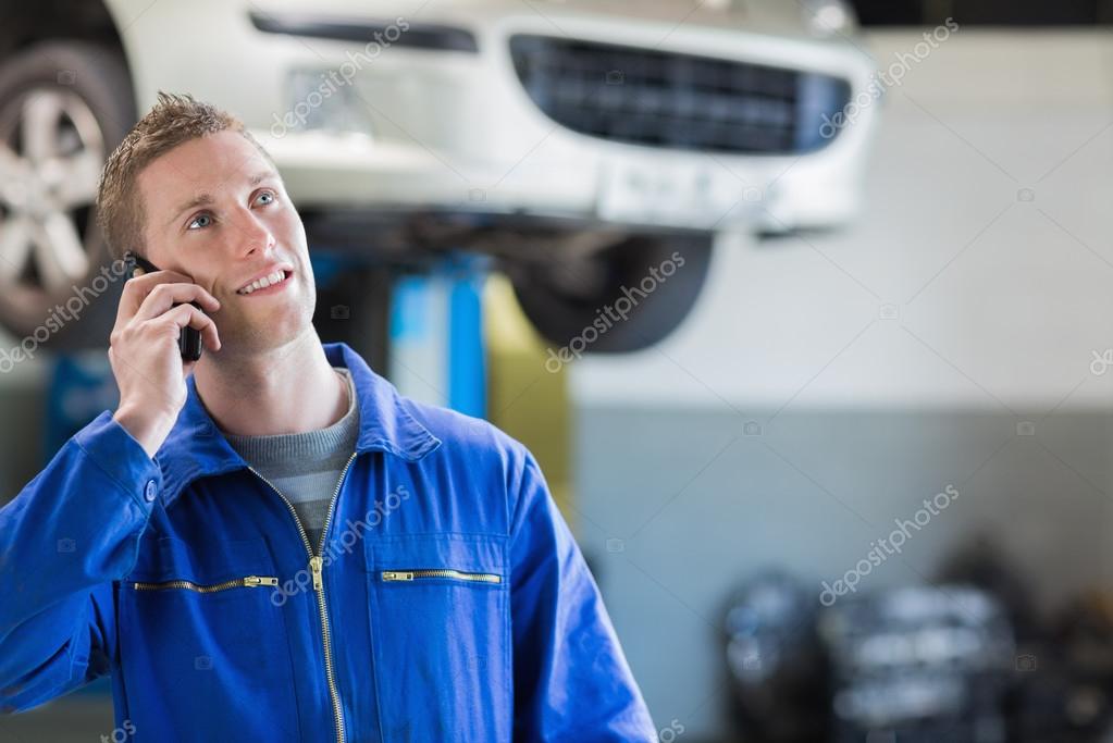 Mechanic using mobile phone Stock Photo by ©Wavebreakmedia 24093339