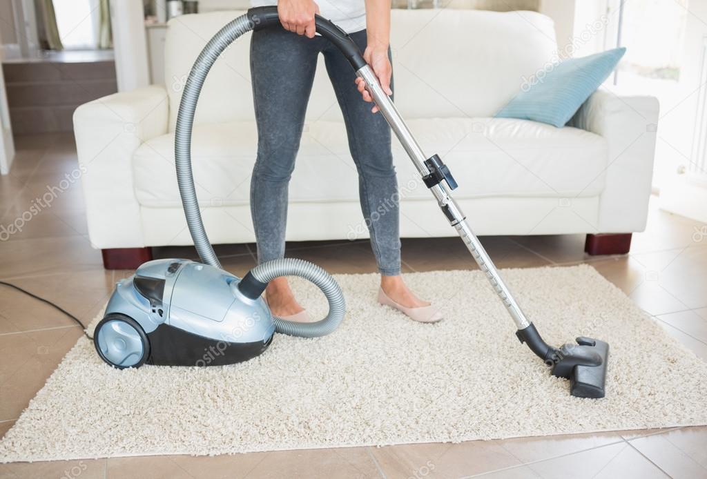 Woman hoovering rug — Stock Photo © Wavebreakmedia 24096763