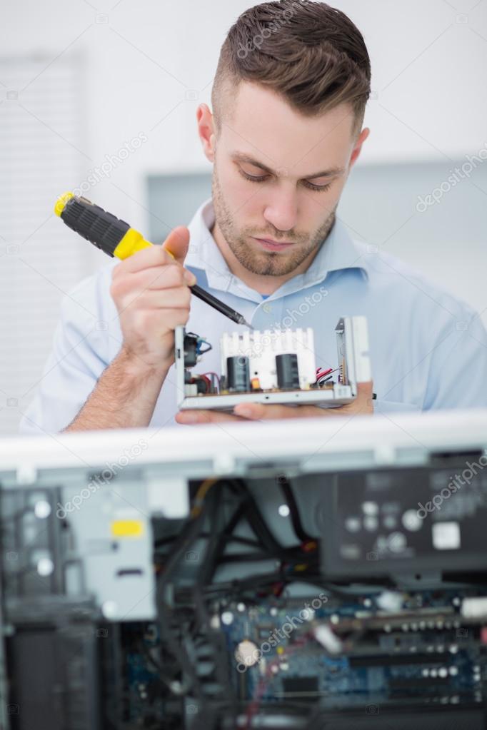 Computer engineer working on cpu part in front of open cpu Stock Photo
