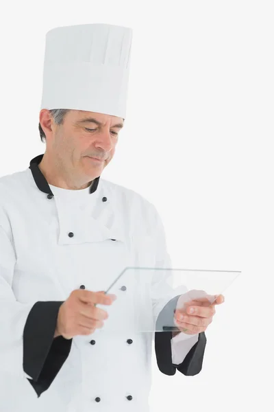 Male chef looking at glass tablet — Stock Photo, Image