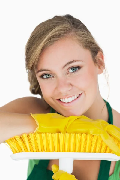 Close-up portrait of young woman with broom — Stock Photo, Image