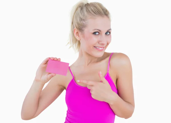 Portrait of beautiful woman pointing at blank card over — Stock Photo, Image