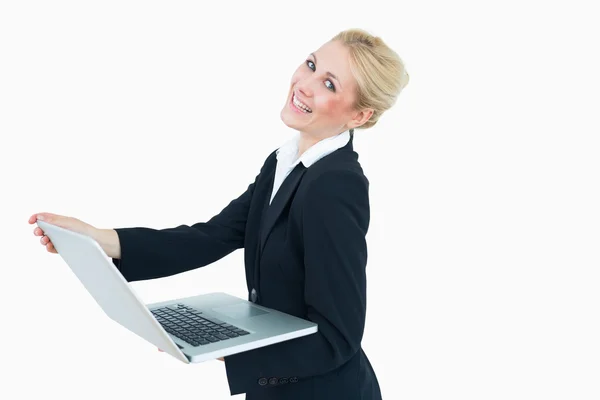 Happy young businesswoman using laptop — Stock Photo, Image