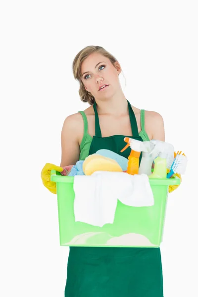 Tied young maid carrying cleaning supplies — Stock Photo, Image