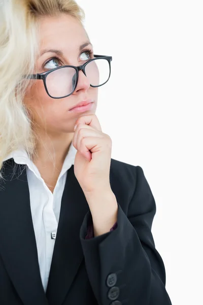 Thoughtful business woman looking up with hand on chin over — Stock Photo, Image