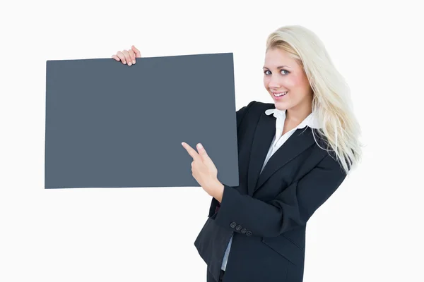 Portrait of business woman pointing at empty banner — Stock Photo, Image