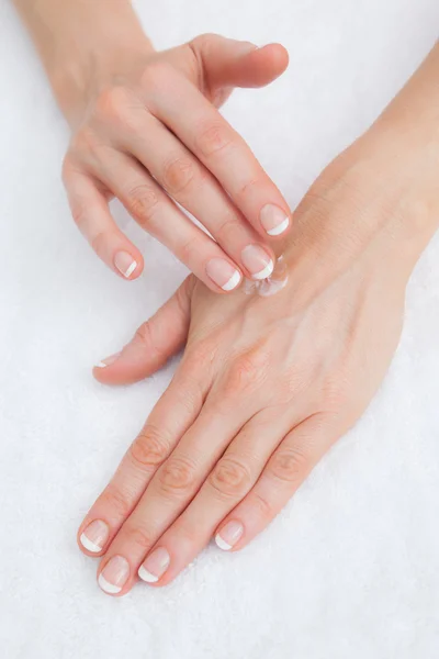 Woman applying cream on hand — Stock Photo, Image