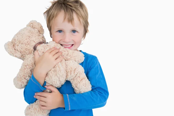 Portrait of happy young boy hugging teddy bear — Stock Photo, Image