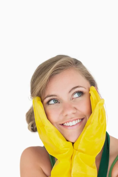 Close-up of smiling young maid with yellow gloves — Stock Photo, Image