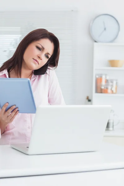 Woman on call while using digital tablet and laptop — Stock Photo, Image