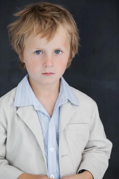 Boy dressed as teacher stands in front of black board — Stock Photo, Image