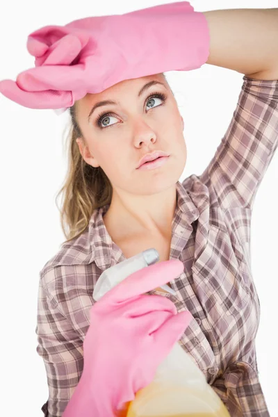 Tired young woman holding spray bottle — Stock Photo, Image