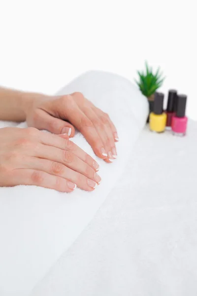 French manicured fingers and nail paint bottles — Stock Photo, Image