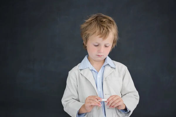 Boy as teacher in front of black board — Stock Photo, Image