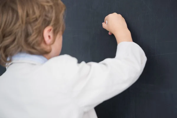 Boy dressed as teacher and writes on black board — Stock Photo, Image