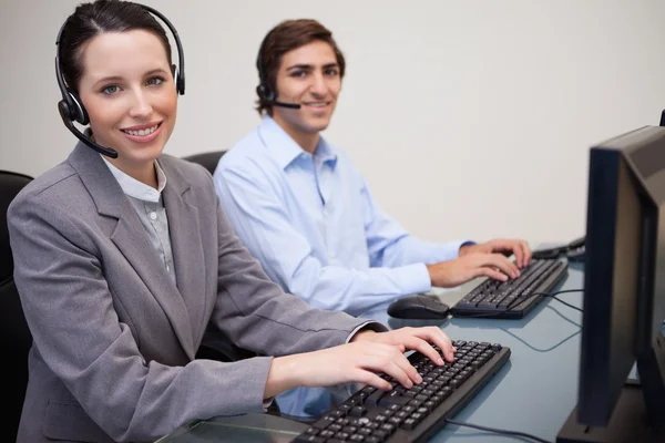 Happy call center employees at work — Stock Photo, Image