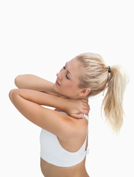 Side view of sporty young woman massaging neck — Stock Photo, Image