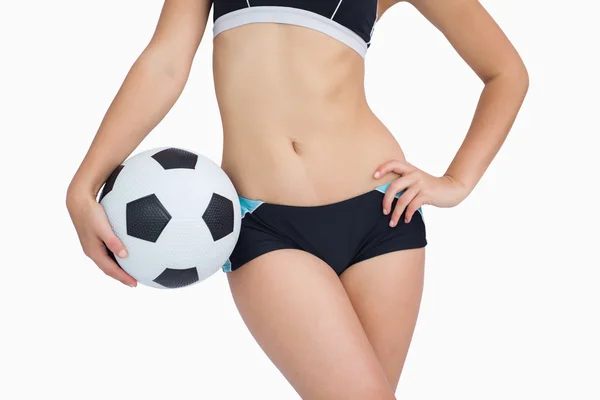 Midsection of fit woman in sportswear with football — Stock Photo, Image