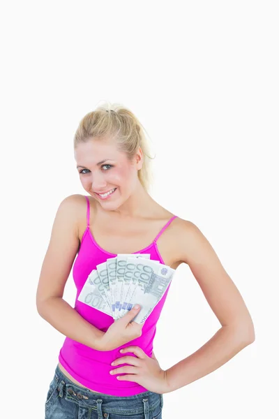 Portrait of happy young woman holding fanned euro banknotes — Stock Photo, Image