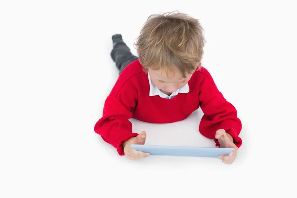 Little boy lying on floor and using digital tablet — Stock Photo, Image