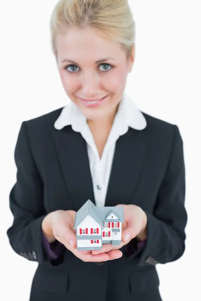 Portrait of business woman holding model house — Stock Photo, Image