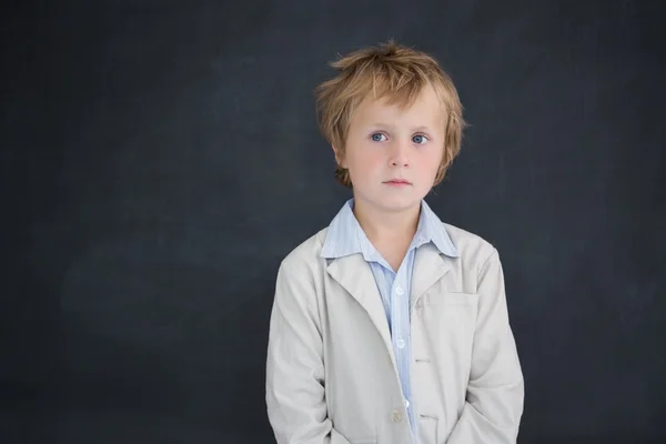 Boy dressed as teacher in front of black board — Stock Photo, Image