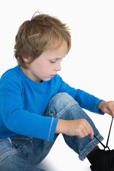 Little boy binding laces — Stock Photo, Image