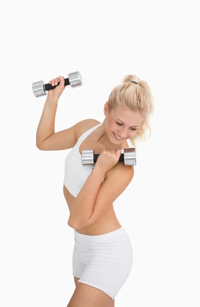Young woman exercising with dumbbells — Stock Photo, Image