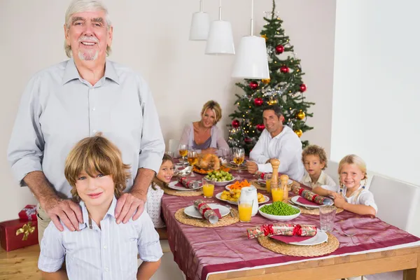 Grandfather and grandson standing beside the dinner table — Stock Photo, Image