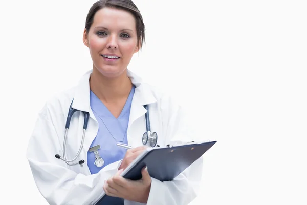 Portrait of smiling female doctor with clipboard — Stock Photo, Image