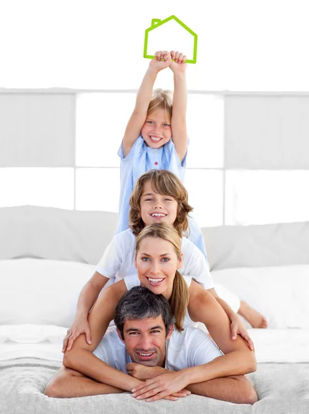 Jolly family having fun with green house illustration — Stock Photo, Image