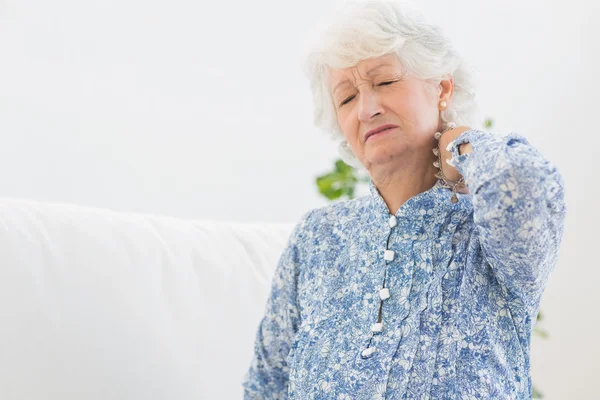 Elderly woman having a neck pain — Stock Photo, Image