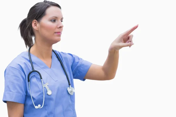 Female surgeon pointing at invisible screen — Stock Photo, Image