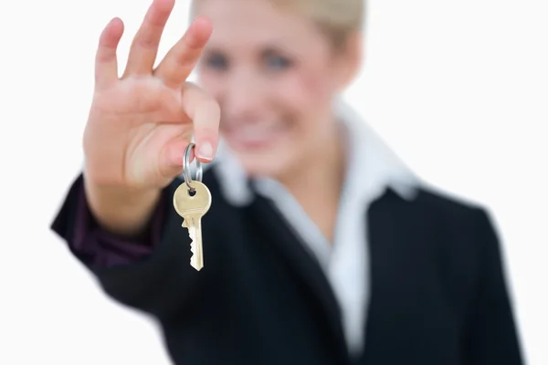 Business woman holding out key Stock Picture
