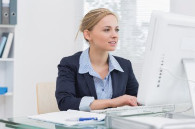 Business woman working on computer at office clipart