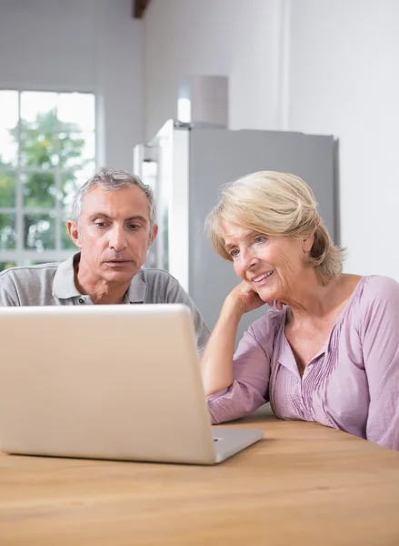Focused couple using a laptop together — Stock Photo, Image