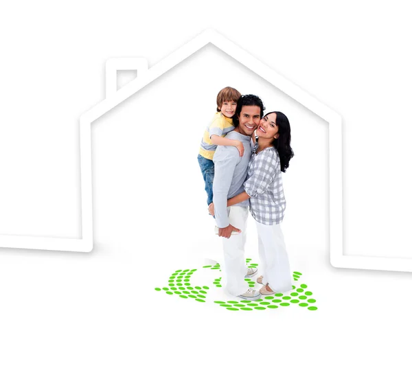 Embracing family standing with a house illustration — Stock Photo, Image