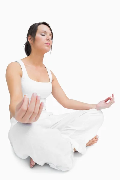 Young woman sitting in lotus position — Stock Photo, Image