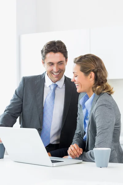 Smiling couple using laptop before work — Stock Photo, Image