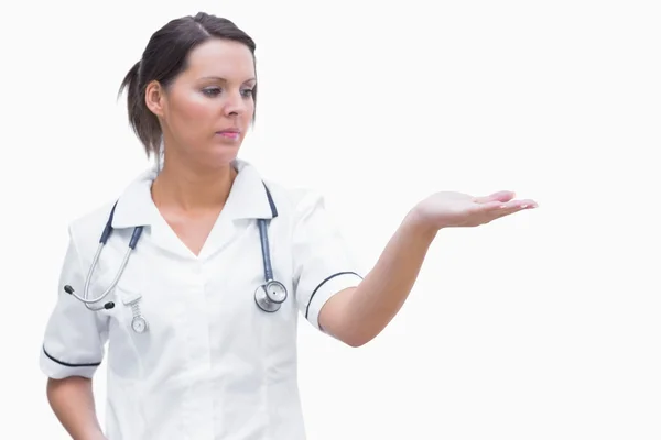 Female nurse holding out open palm — Stock Photo, Image