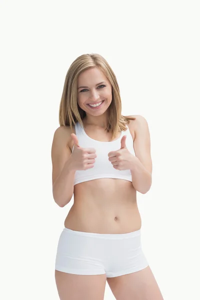 Retrato de mujer feliz en ropa deportiva haciendo gestos de doble pulgar hacia arriba — Foto de Stock