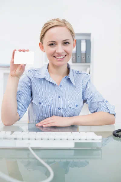 Portrait of female executive holding blank card at office — Stock Photo, Image