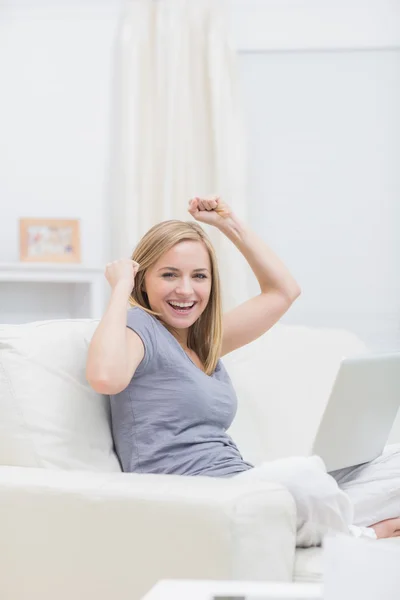 Portrait of excited casual woman with laptop at home — Stock Photo, Image