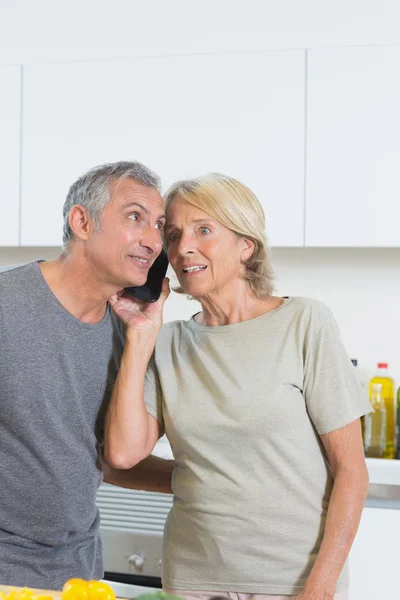 Mature couple listening a call together — Stock Photo, Image