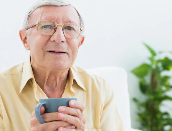 Elderly man with a cup — Stock Photo, Image