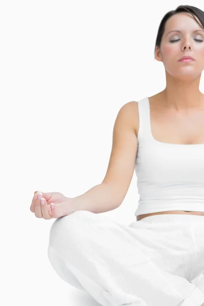 Young woman sitting in lotus position — Stock Photo, Image