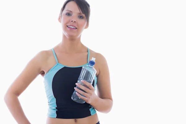 Portrait of young woman in sportswear holding water bottle — Stock Photo, Image